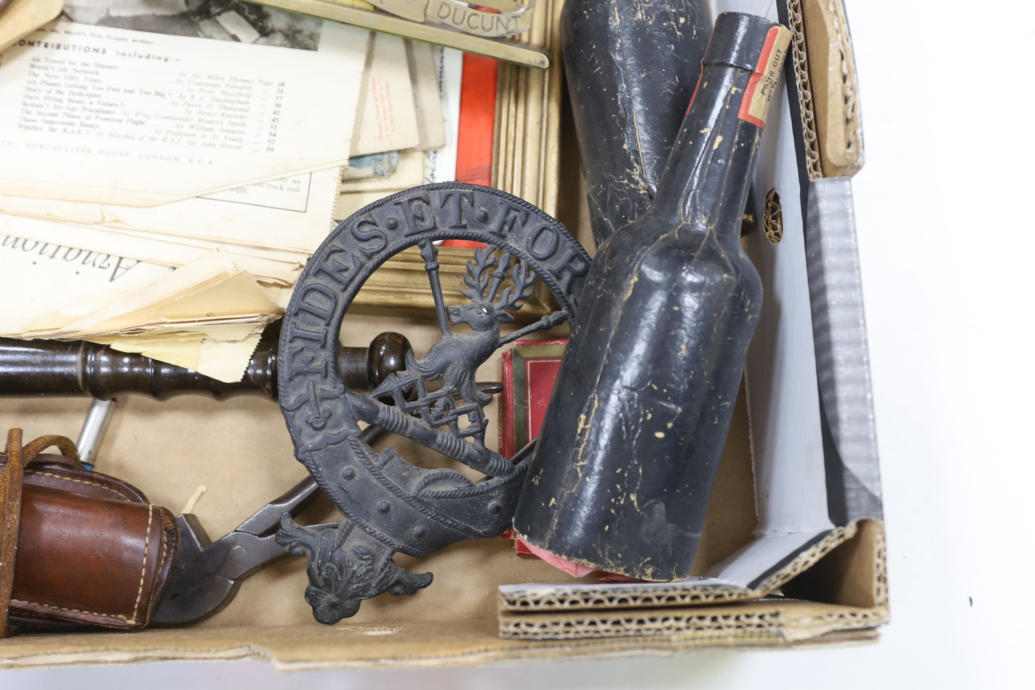 A collection of Militaria and other items, including a Royal Artillery brass cased timepiece, headphones, crepe paper bunting contained in a card Worthington’s IPA beer bottle, etc.